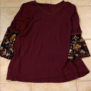 Burgundy shirt with a V-neck and ruffled sleeves